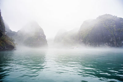 Scenic view of waterfall in foggy weather