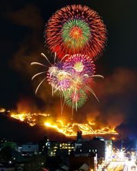 Low angle view of firework display at night