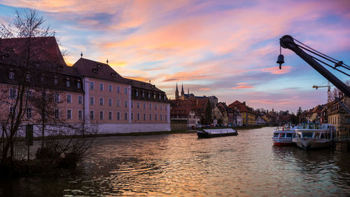 Boats in river at sunset