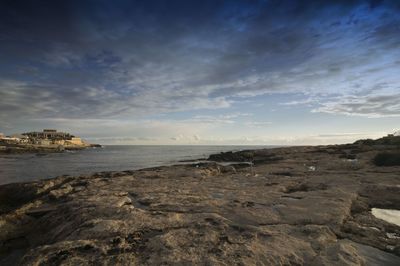 Scenic view of sea against cloudy sky