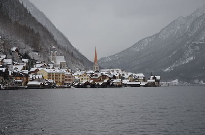 Scenic view of sea and buildings against sky