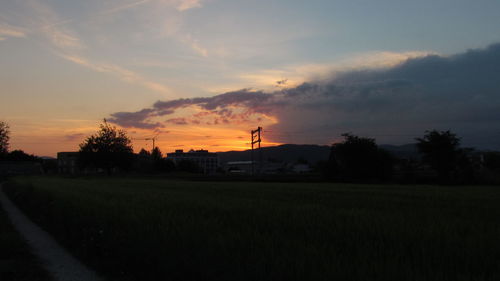 Scenic view of field against sky during sunset