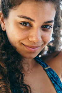 Close-up portrait of smiling young woman