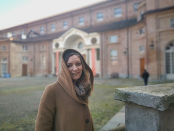 Portrait of a smiling young woman in city