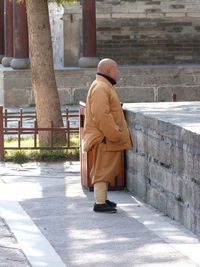 Rear view of man in front of built structure