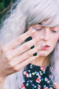 Close-up of woman holding blackberries