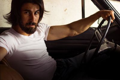 Portrait of young man in car