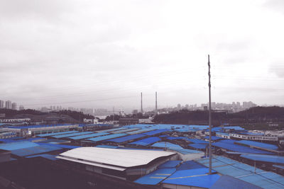 View of harbor against cloudy sky