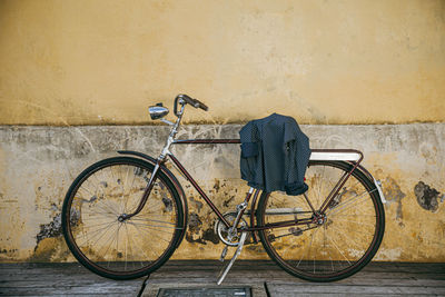 Bicycle parked against wall