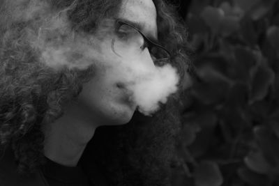 Close-up of mature man smoking outdoors