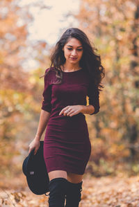 Portrait of young woman in autumn leaves