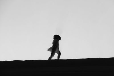 Low angle view of woman against clear sky