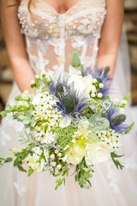 Midsection of woman holding flower bouquet