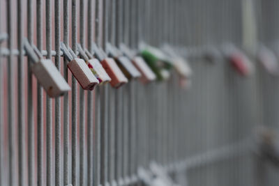 Close-up of clothes hanging on metal fence
