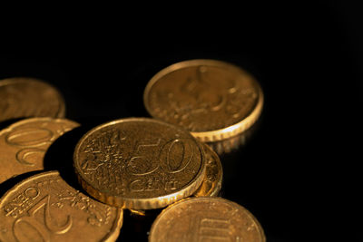 Close-up of coins on black background