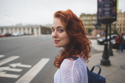 Portrait of woman standing on city street