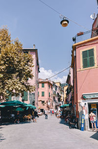 Street amidst buildings in city against sky