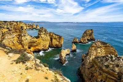 Algarve cliffs and coastline overlooking the atlantic ocean viewed from ponta da piedade, portugal