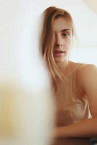 Portrait of beautiful young woman at home