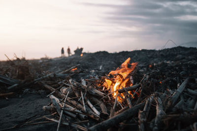 Close-up of bonfire against sky during sunset