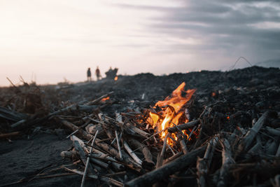 Close-up of bonfire against sky at sunset