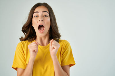 Portrait of teenage girl standing against white background