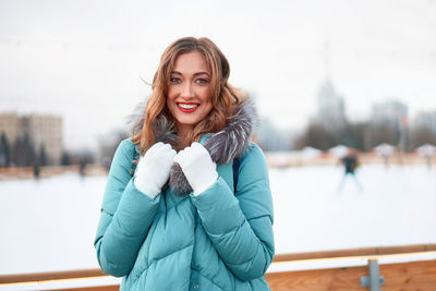 Portrait of smiling young woman standing outdoors