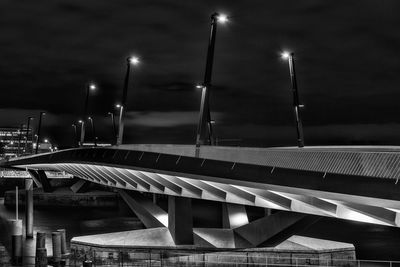Illuminated baakenhafen bridge over river against sky at night
