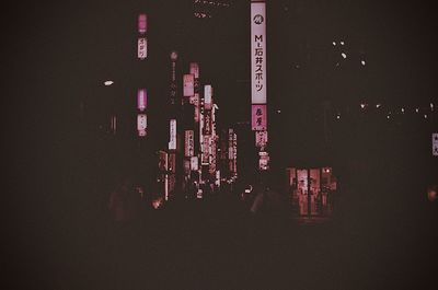 Illuminated cityscape against sky at night