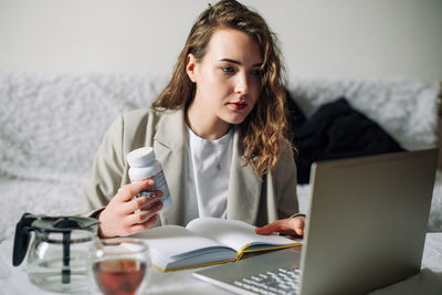 Young woman using laptop at home