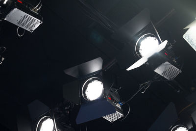 Low angle view of illuminated lighting equipment