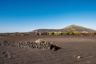 Scenic view of land against clear blue sky