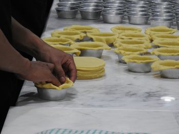 Midsection of man preparing food in kitchen