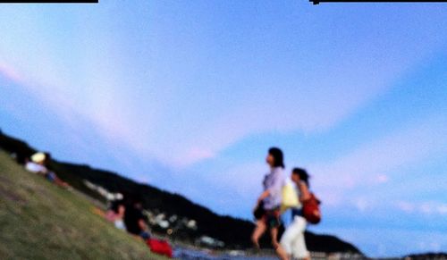 Silhouette of people against blue sky