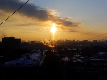 Silhouette cityscape against sky during sunset