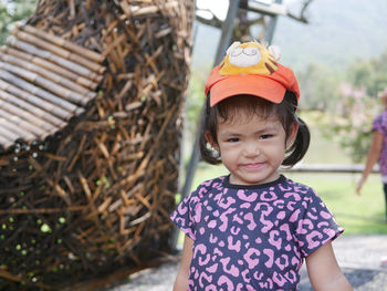 Portrait of cute smiling girl standing outdoors