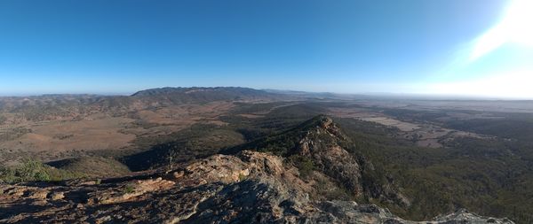 Scenic view of mountains against clear blue sky