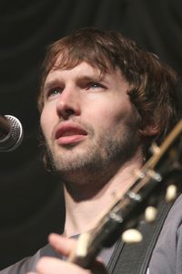 Portrait of young man playing guitar