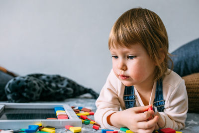 Close-up of boy playing with toy at home