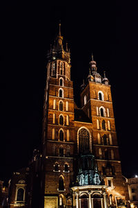 Low angle view of illuminated building against sky at night