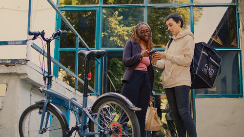 Low angle view of woman with bicycle