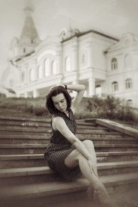 Portrait of young woman sitting on steps