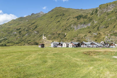 Small village in the mountains with stone houses, flowers and a river in val formazza