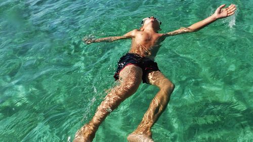 High angle view of boy swimming in sea