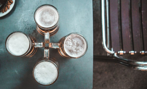 Close-up of beer glasses on table