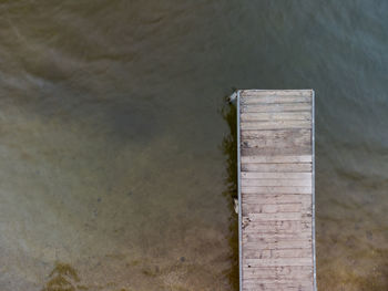 High angle view of wooden post on pier over lake