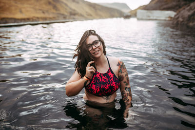 Portrait of smiling young woman in lake