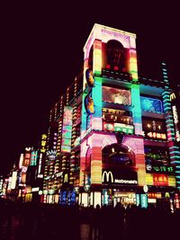 Low angle view of illuminated building at night