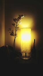 Close-up of illuminated lamp on table at home