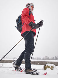 Full length of man skiing on snow against mountain